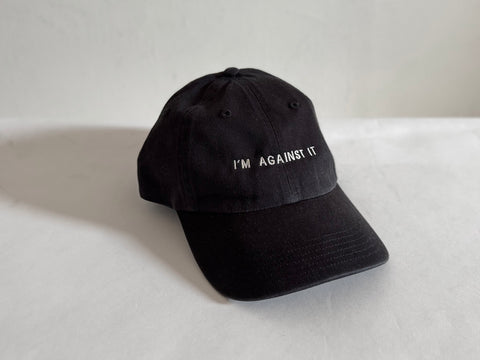 'I'M AGAINST IT' CAP. BLACK. 100% COTTON